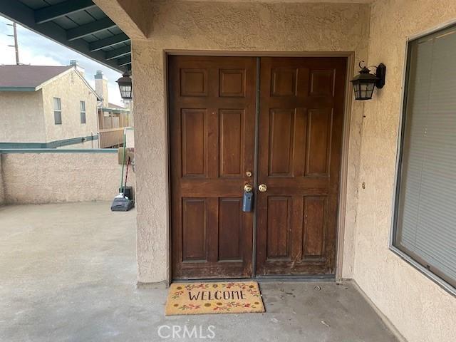entrance to property featuring stucco siding