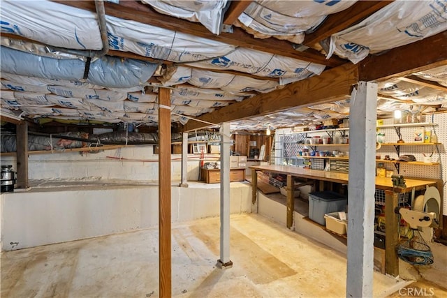 unfinished basement with a workshop area