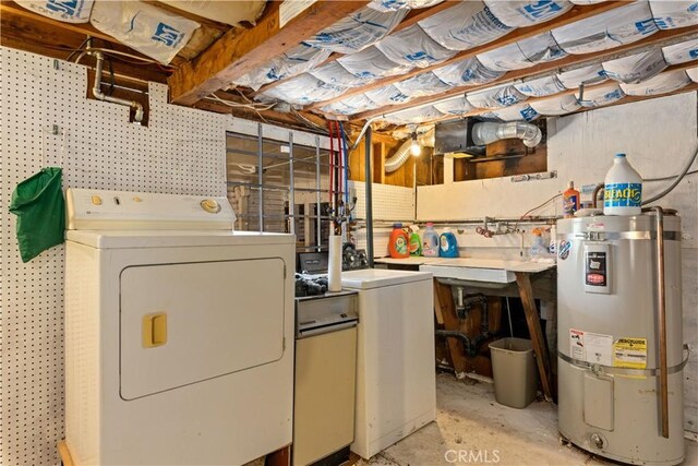 laundry room featuring a workshop area, water heater, washer and dryer, and laundry area