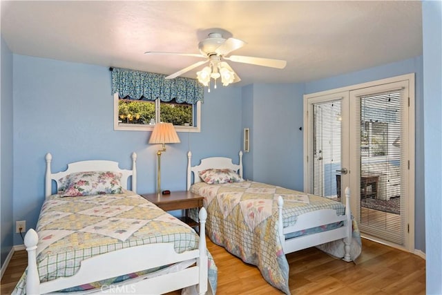 bedroom with wood finished floors, ceiling fan, french doors, baseboards, and access to outside