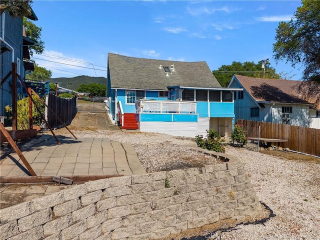 view of pool with a sunroom, a patio, and fence