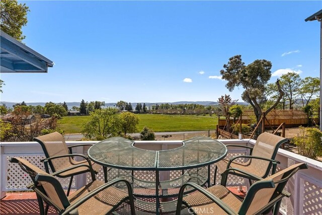view of patio with a mountain view and outdoor dining space