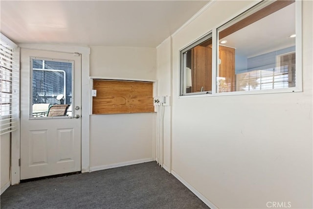 entryway featuring baseboards and carpet