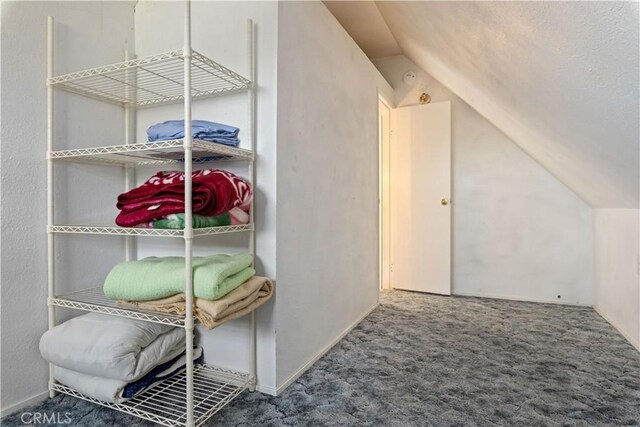 bonus room featuring lofted ceiling and carpet