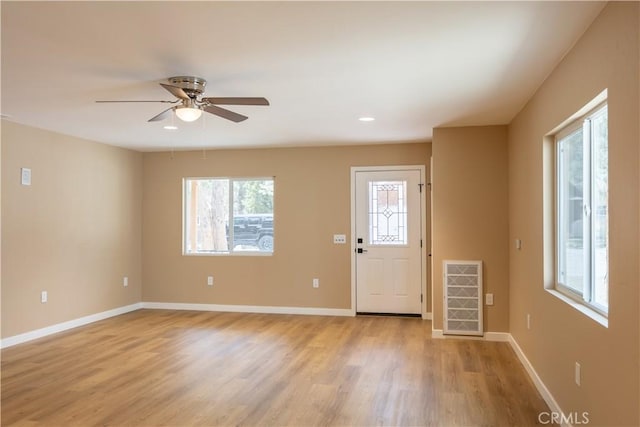 entrance foyer featuring ceiling fan, baseboards, visible vents, and light wood-style flooring