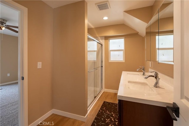 bathroom featuring a shower stall, a sink, ceiling fan, baseboards, and visible vents