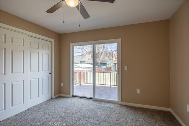unfurnished bedroom featuring baseboards, carpet flooring, access to outside, and ceiling fan