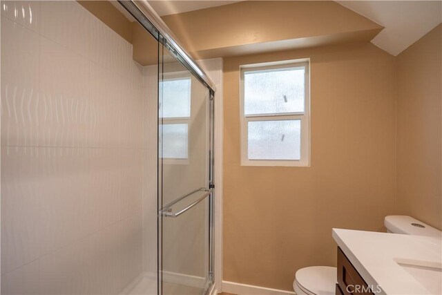 full bath featuring a shower stall, toilet, and vanity