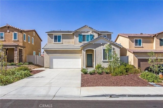 traditional-style home with fence, a tiled roof, stucco siding, an attached garage, and driveway