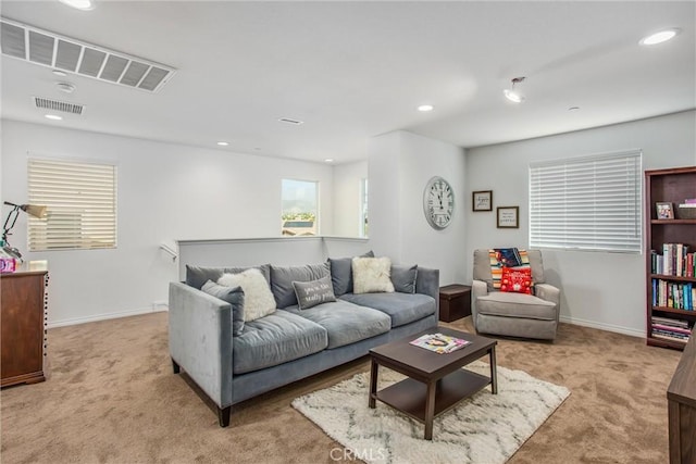 carpeted living area with baseboards, visible vents, and recessed lighting