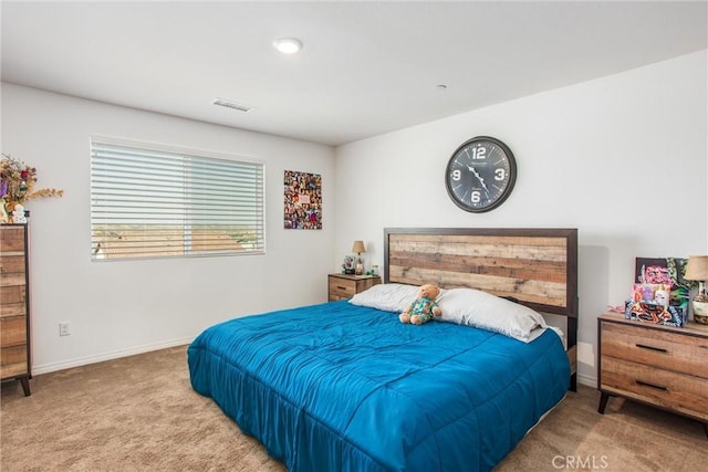 carpeted bedroom featuring visible vents and baseboards