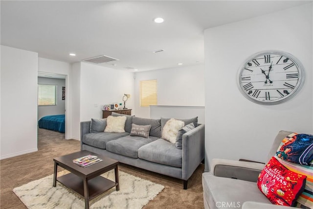 living area featuring recessed lighting, visible vents, and carpet flooring