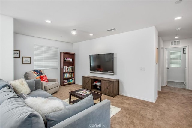 carpeted living area with baseboards, visible vents, and recessed lighting
