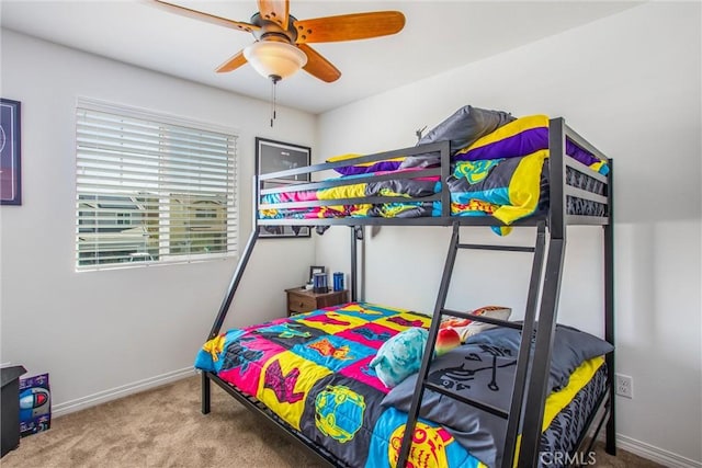 carpeted bedroom featuring a ceiling fan and baseboards