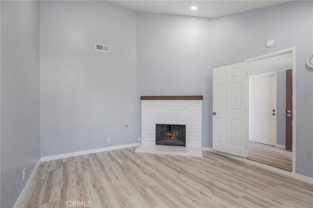 13261 Coast St, Garden Grove, CA 92844 - unfurnished living room featuring wood finished floors, a brick fireplace, baseboards, and recessed lighting