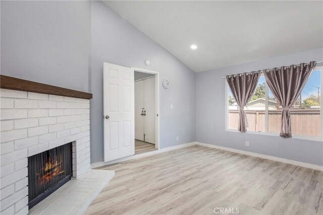 13261 Coast St, Garden Grove, CA 92844 - unfurnished living room featuring lofted ceiling, a fireplace, light wood finished floors, baseboards, and recessed lighting