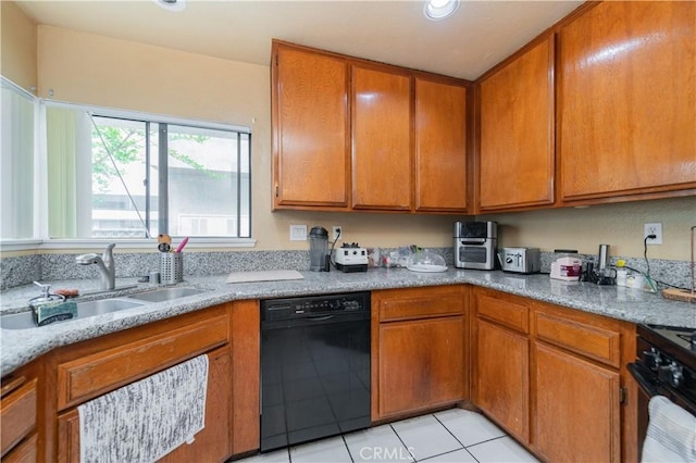 kitchen featuring a sink, light tile patterned flooring, brown cabinets, light stone counters, and dishwasher