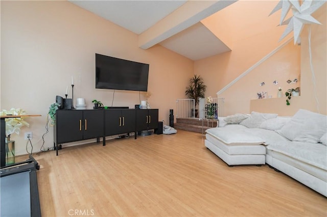 living area featuring wood finished floors and beam ceiling