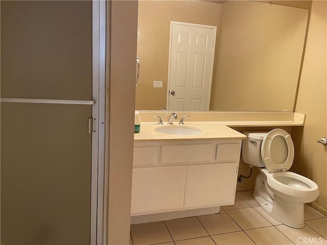 bathroom with vanity, tile patterned flooring, and toilet