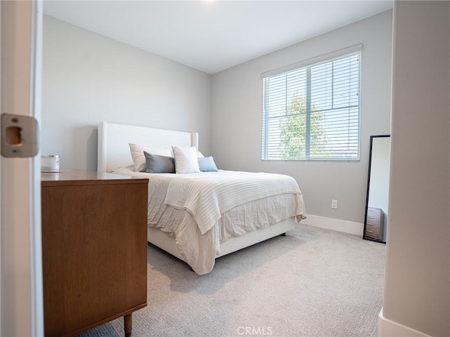 carpeted bedroom featuring baseboards