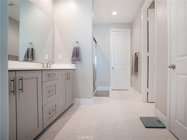 bathroom with recessed lighting, a shower stall, tile patterned flooring, vanity, and baseboards