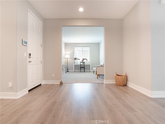 interior space with baseboards, light wood-style floors, and recessed lighting