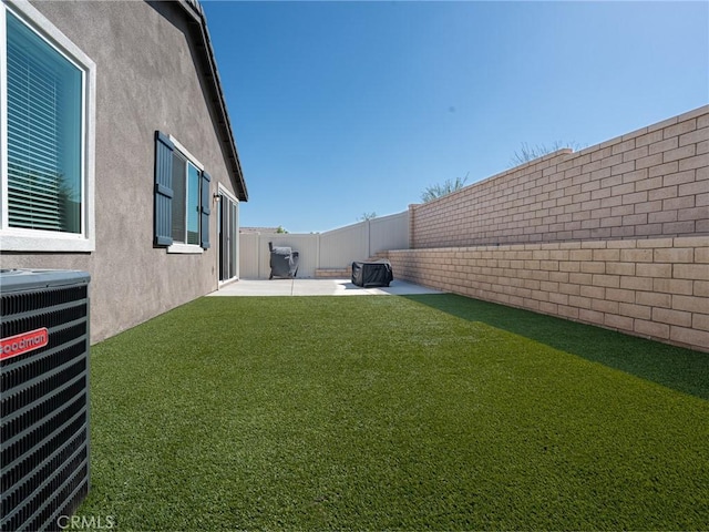 view of yard featuring central air condition unit, a patio area, and a fenced backyard