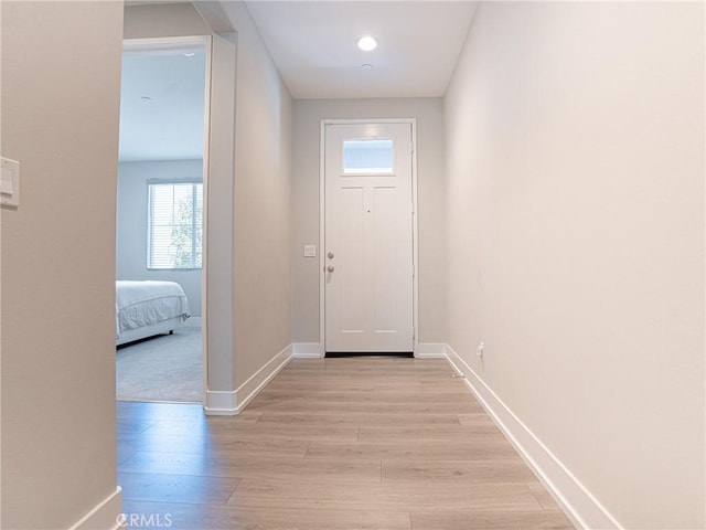 entryway featuring light wood-style flooring and baseboards