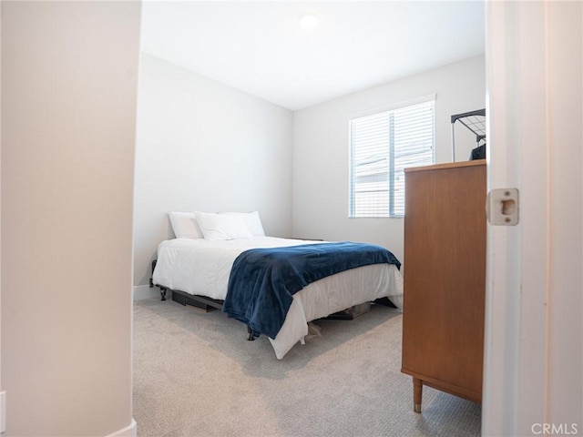 bedroom featuring carpet floors and baseboards