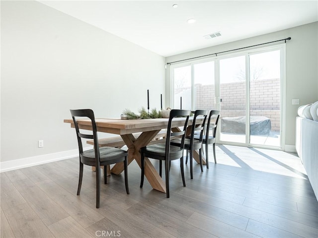 dining area featuring baseboards, wood finished floors, visible vents, and recessed lighting