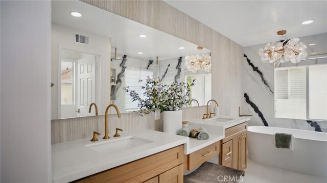 44 Statehouse Pl, Irvine, CA 92602 - bathroom with vanity, a healthy amount of sunlight, visible vents, and a soaking tub