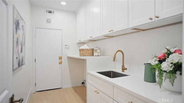44 Statehouse Pl, Irvine, CA 92602 - washroom with recessed lighting, visible vents, a sink, and light wood finished floors