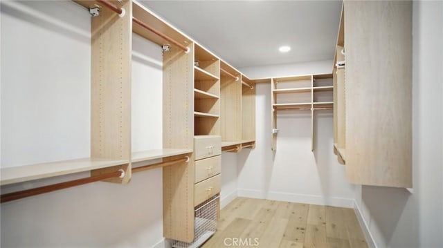 44 Statehouse Pl, Irvine, CA 92602 - walk in closet featuring built in desk and light wood finished floors