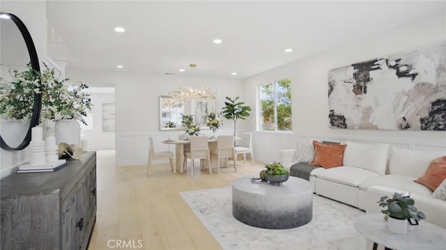 44 Statehouse Pl, Irvine, CA 92602 - living area with light wood finished floors, a decorative wall, a chandelier, a wainscoted wall, and recessed lighting