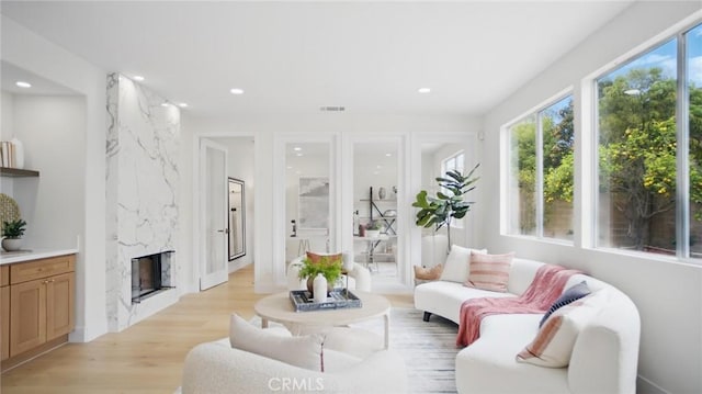 44 Statehouse Pl, Irvine, CA 92602 - living room with a fireplace, recessed lighting, visible vents, and light wood-type flooring