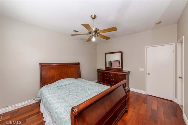 bedroom with baseboards, visible vents, dark wood-style floors, and ceiling fan