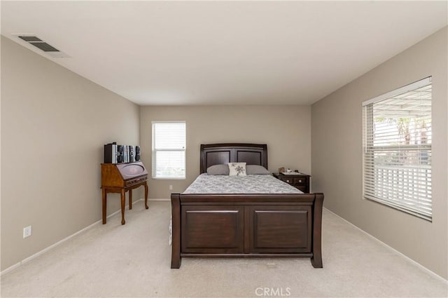 bedroom with light carpet, baseboards, and visible vents