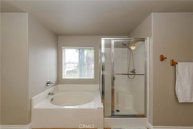 bathroom with a bath and a stall shower