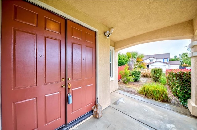 entrance to property with stucco siding