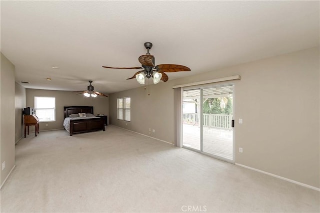 unfurnished bedroom with light carpet, baseboards, ceiling fan, and access to exterior