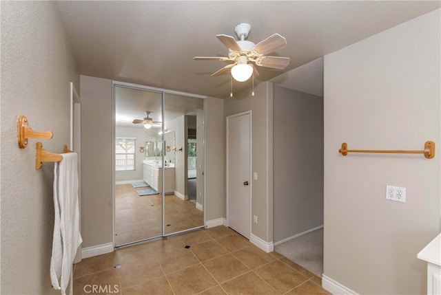 interior space with baseboards and light tile patterned floors