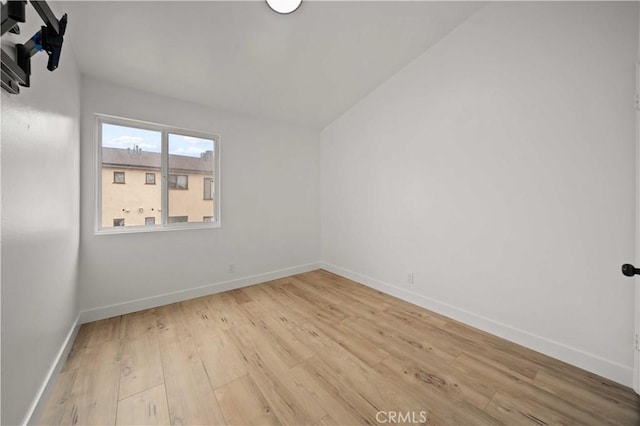 unfurnished room featuring light wood-type flooring and baseboards