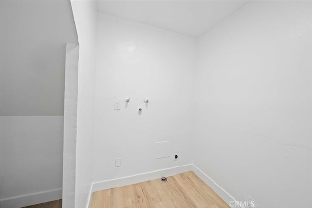 laundry area with wood finished floors, baseboards, and washer hookup