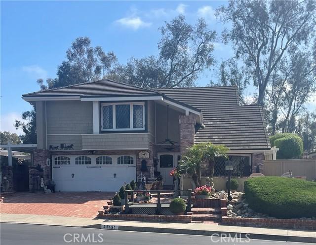 22191 Apache Dr, Lake Forest, CA 92630 - tri-level home featuring decorative driveway, an attached garage, and fence