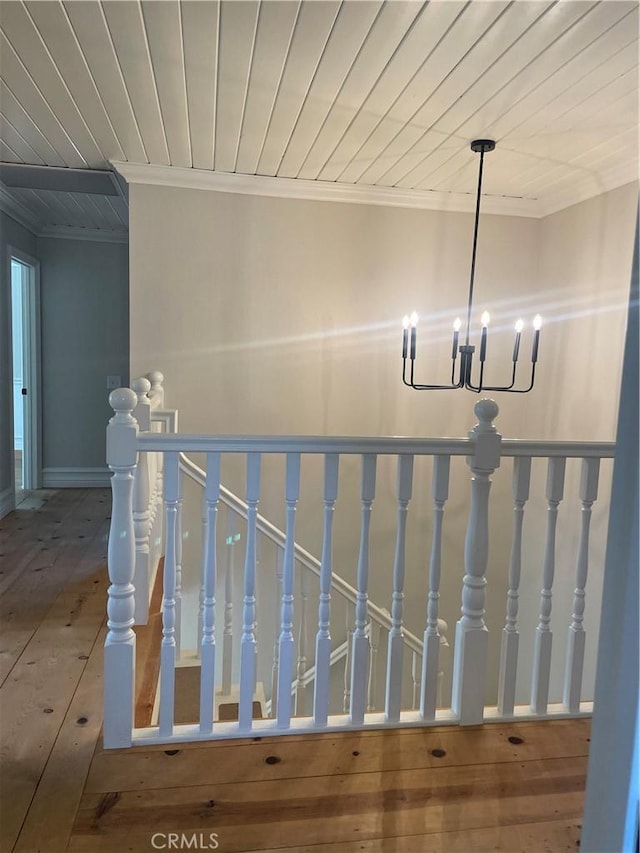 22191 Apache Dr, Lake Forest, CA 92630 - stairway featuring crown molding, a notable chandelier, wood ceiling, and hardwood / wood-style floors