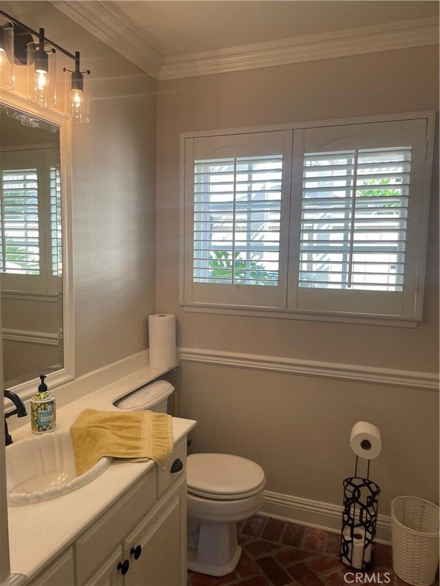 22191 Apache Dr, Lake Forest, CA 92630 - half bathroom with vanity, ornamental molding, toilet, baseboards, and brick floor