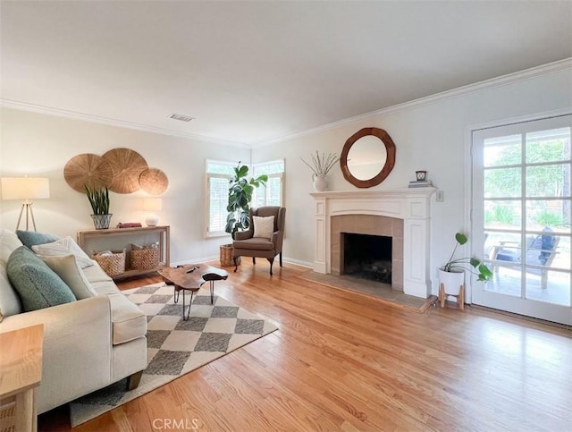 322 Calle De Arboles, Redondo Beach, CA 90277 - living room with light wood finished floors, healthy amount of natural light, crown molding, a fireplace, and baseboards