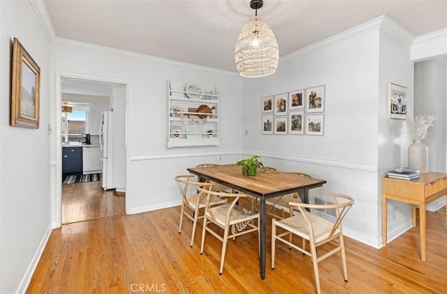 322 Calle De Arboles, Redondo Beach, CA 90277 - dining space featuring light wood finished floors, crown molding, and a chandelier