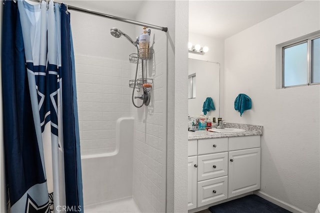 bathroom featuring curtained shower and vanity