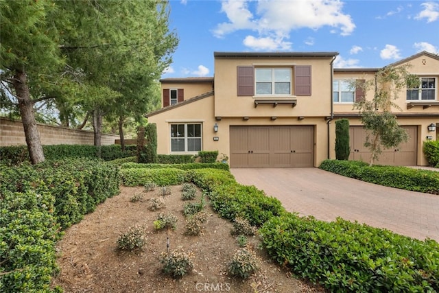 21 Deergrass, Irvine, CA 92618 - multi unit property with decorative driveway, an attached garage, and stucco siding